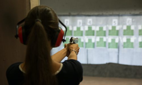 woman-aiming-gun-in-shooting-range.jpg